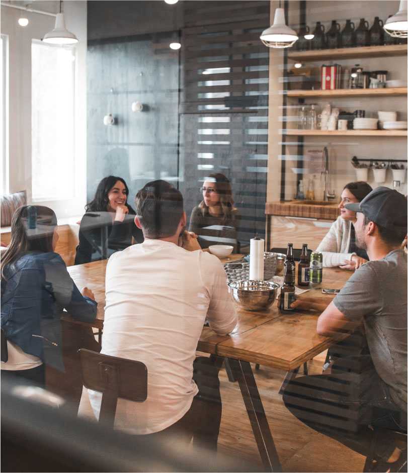 Youthful company having a business meeting in a coffee shop